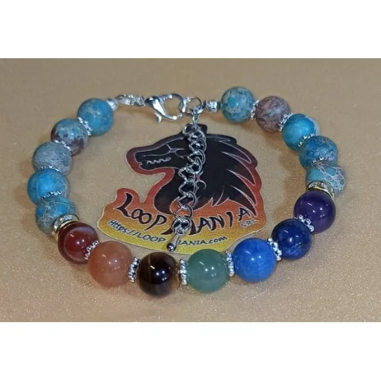 Bratara 7 chakre cu accesorii placate cu argint. Bratara pe elastic sau sarma siliconata cu incuietoare lobster placat cu argint, din diferite margele semipretioase 8 sau 6 mm si 7 chakre: carneol, jad portocaliu, ochi de tigru, aventurin verde, jasp impe